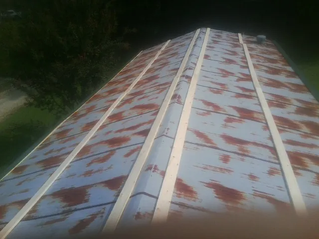 Rusted metal roof panels with new wood purlins before replacement — Storm Damage Roof Repair in Atlantic Beach by Roofing Brothers